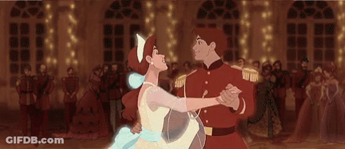 A Man And A Woman Are Dancing In Front Of A Crowd . GIF