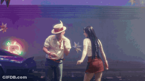 A Man And A Woman Are Dancing In Front Of A Neon Sign That Says ' Coca Cola ' GIF