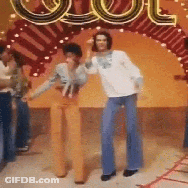 A Man And A Woman Are Dancing In Front Of A Sign That Says ' Cool ' GIF