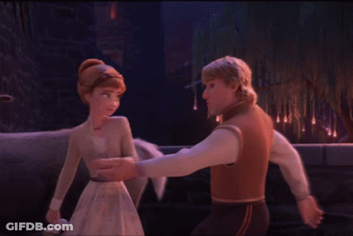 A Man And A Woman Are Dancing In Front Of A Tree GIF