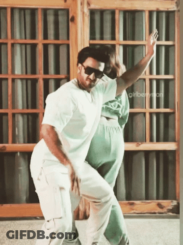 A Man And A Woman Are Dancing In Front Of A Window With The Words Girlberryman On The Bottom GIF