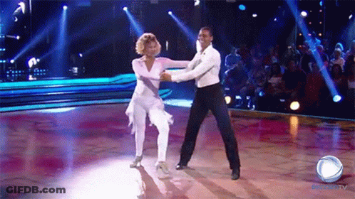 A Man And A Woman Are Dancing On A Dance Floor In Front Of A Crowd That Is Watching A Show On Globo Tv GIF