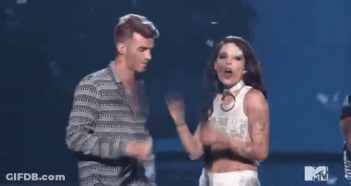 A Man And A Woman Are Dancing On A Stage At A Mtv Event . GIF