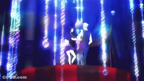 A Man And A Woman Are Dancing On A Stage In Front Of A Blue Background . GIF