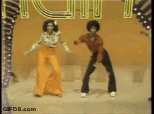 A Man And A Woman Are Dancing On A Stage In Front Of A Sign That Says ' I Love You ' . GIF