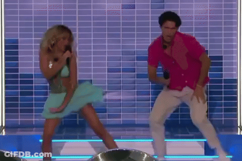 A Man And A Woman Are Dancing On A Stage In Front Of A Tiled Wall . GIF