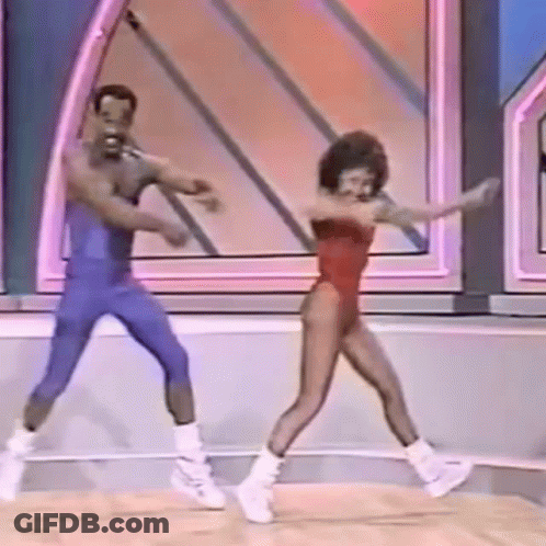 A Man And A Woman Are Dancing On A Stage On A Show . GIF