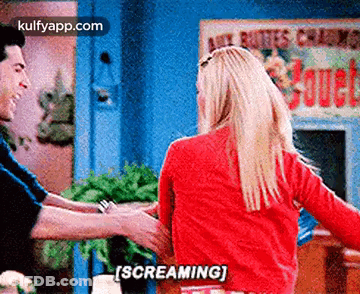 A Man And A Woman Are Dancing Together And The Woman Is Screaming While Holding The Man 'S Arm . GIF