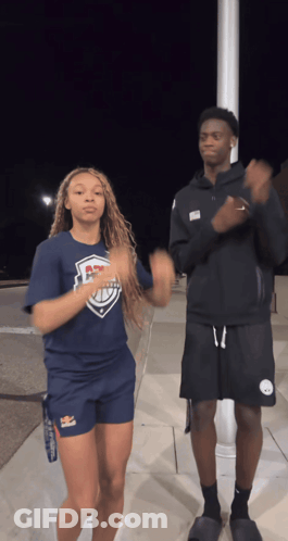 A Man And A Woman Are Dancing Together And The Woman Is Wearing A Shirt That Says ' Ucsd ' On It GIF