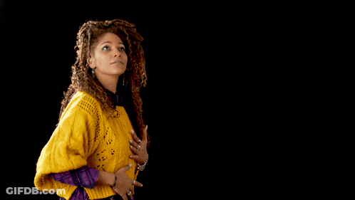 A Man And A Woman Are Dancing Together And The Woman Is Wearing A Yellow Sweater GIF