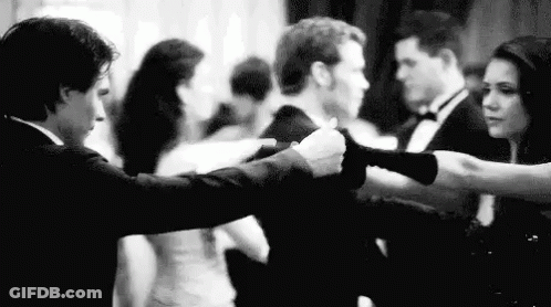 A Man And A Woman Are Dancing Together At A Party . GIF