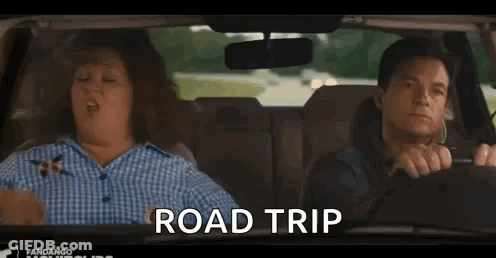 A Man And A Woman Are Driving A Car And The Woman Is Making A Gesture That Says `` Road Trip '' . GIF