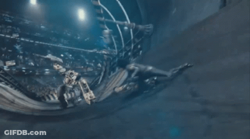 A Man And A Woman Are Fighting Each Other In A Room . GIF