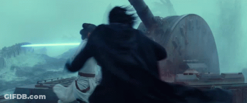 A Man And A Woman Are Fighting Each Other In Front Of A Large Clock . GIF