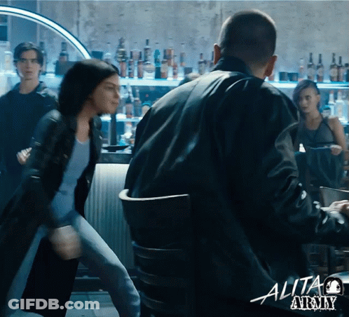 A Man And A Woman Are Fighting In A Bar With A Sign That Says Alita At The Bottom GIF