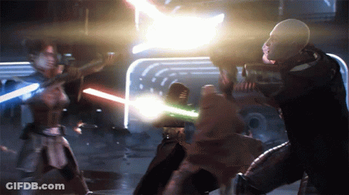 A Man And A Woman Are Fighting With Lightsabers In A Dark Room GIF