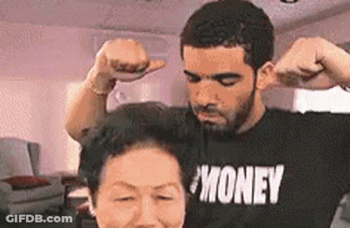 A Man And A Woman Are Flexing Their Muscles In A Living Room . GIF