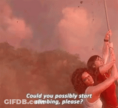 A Man And A Woman Are Hanging From A Rope . GIF