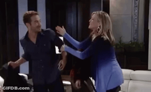 A Man And A Woman Are Having A Fight In A Living Room . GIF