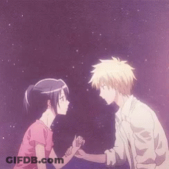 A Man And A Woman Are Holding Hands And Looking At Each Other GIF