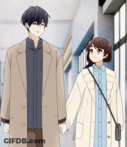 A Man And A Woman Are Holding Hands And Smiling GIF