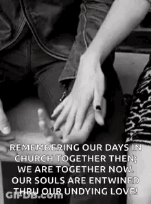 A Man And A Woman Are Holding Hands In A Black And White Photo . GIF