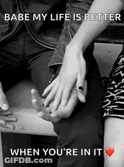 A Man And A Woman Are Holding Hands In A Black And White Photo With A Quote . GIF