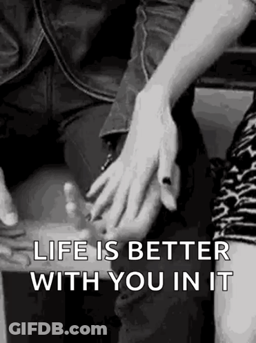 A Man And A Woman Are Holding Hands In A Black And White Photo With The Words `` Life Is Better With You In It '' . GIF