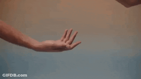 A Man And A Woman Are Holding Hands In A Close Up Of Their Hands . GIF