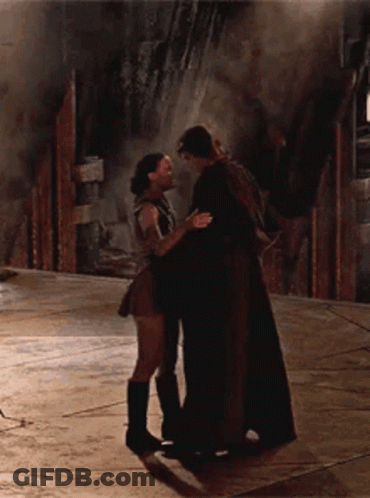 A Man And A Woman Are Hugging And Kissing On The Floor GIF
