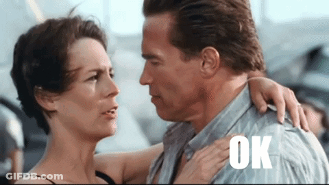 A Man And A Woman Are Hugging And The Word Ok Is On The Shoulder Of The Man GIF