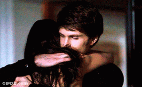 A Man And A Woman Are Hugging Each Other GIF