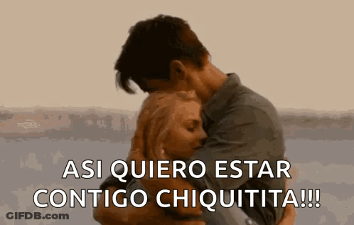 A Man And A Woman Are Hugging Each Other And The Man Is Saying `` Asi Quiero Estar Contigo Chiquita '' . GIF