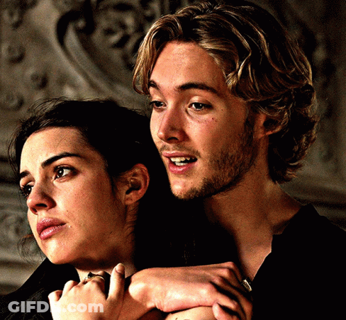 A Man And A Woman Are Hugging Each Other And The Man Is Smiling GIF