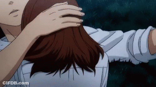 A Man And A Woman Are Hugging Each Other And The Woman Is Touching The Man 'S Hair . GIF