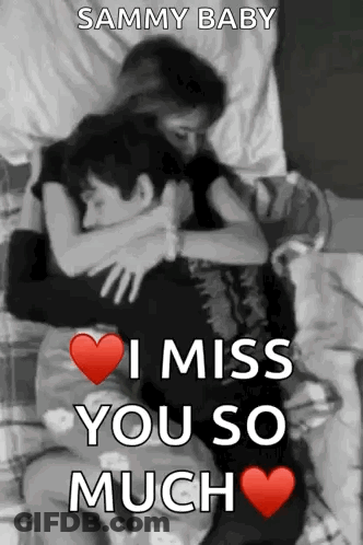 A Man And A Woman Are Hugging Each Other In A Bed . GIF