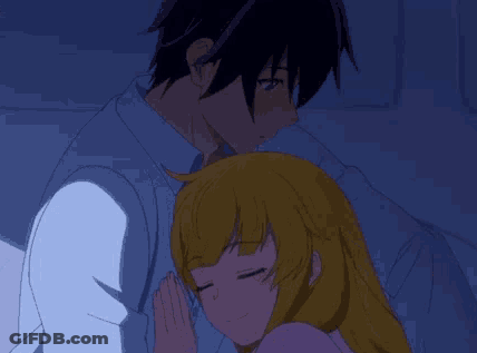 A Man And A Woman Are Hugging Each Other In A Dark Room . GIF