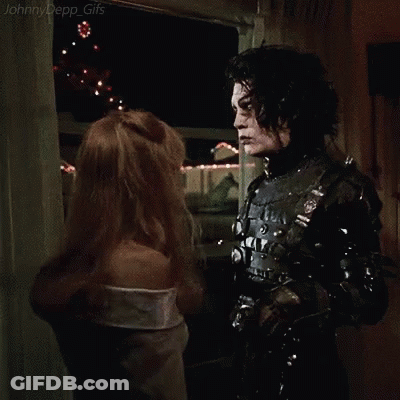 A Man And A Woman Are Hugging Each Other In A Room In A Movie . GIF