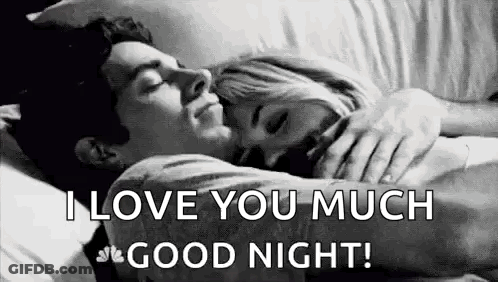 A Man And A Woman Are Hugging Each Other In Bed . GIF
