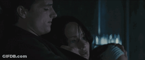 A Man And A Woman Are Hugging Each Other In The Dark . GIF