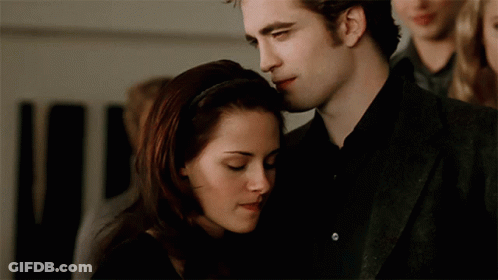 A Man And A Woman Are Hugging Each Other GIF