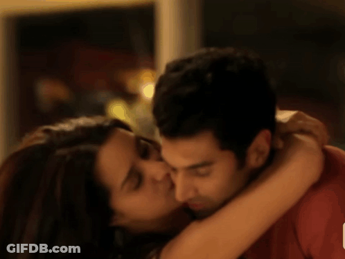 A Man And A Woman Are Hugging Each Other GIF