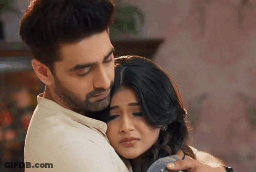 A Man And A Woman Are Hugging Each Other GIF