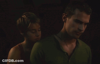 A Man And A Woman Are Hugging In The Dark GIF