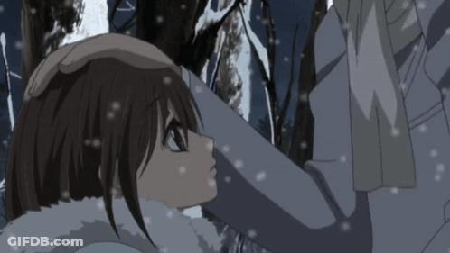 A Man And A Woman Are Hugging In The Snow GIF