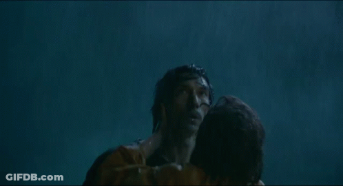 A Man And A Woman Are Hugging In The Water And The Woman Is Holding The Man 'S Neck . GIF