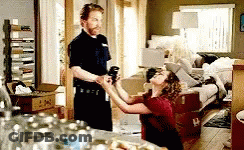 A Man And A Woman Are In A Living Room . GIF
