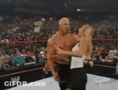 A Man And A Woman Are In A Wrestling Ring . GIF