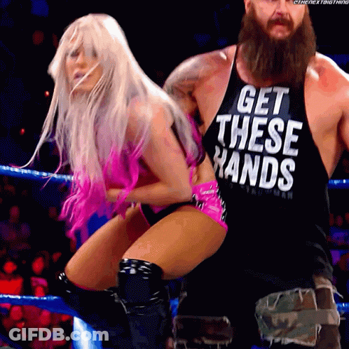 A Man And A Woman Are In A Wrestling Ring And The Man Is Wearing A Tank Top That Says Get These Hands GIF