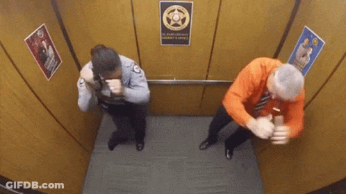 A Man And A Woman Are In An Elevator With A Sign That Says El Paso County Sheriff 'S Office GIF